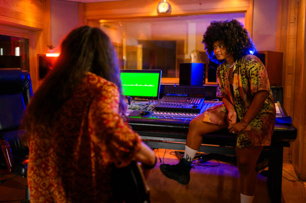 istock Young composer sitting in a music studio while her music is being recorded. 1769425767