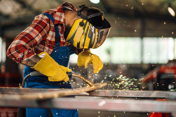 istock Worker in the factory welding metal with welding machine with caution. 1769425837