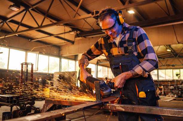 istock Skilled caucasian man with safety gear operating with the grinder. 1769426076