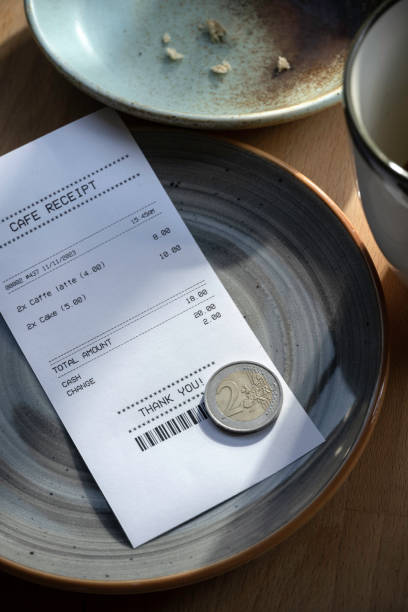 istock Cafe receipt and cash on cafe table. 1769428210