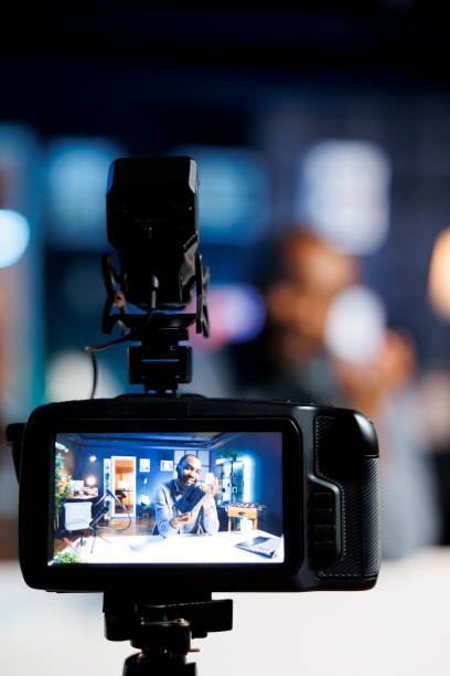 istock Man filming V mount accumulator review 1769429698