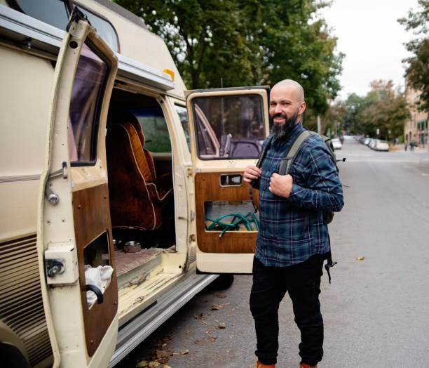istock Millennial man ready to go for a week-end in vintage camper van. 1769452526