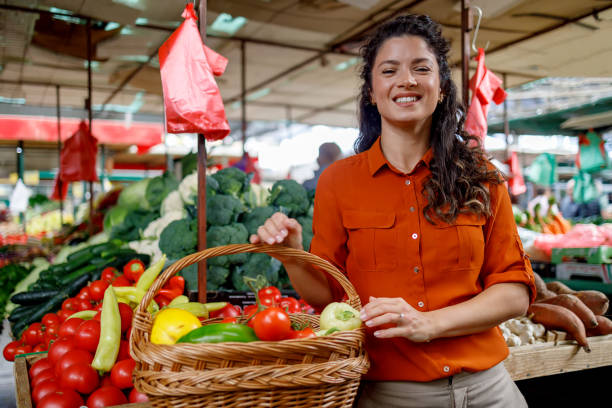 istock Woman navigates vegetable section 1769453637