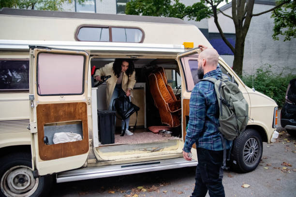 istock Millennial couple ready to go on a week-end in vintage camper van. 1769453642
