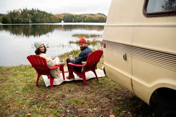 istock Millennial couple enjoying a week-end in vintage camper van. 1769454690
