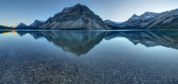 landscape of snow mountain reflecting in the lake in the morning