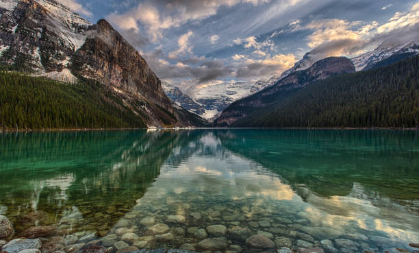 istock Clouds and mtns reflect in mountain lake 176946500