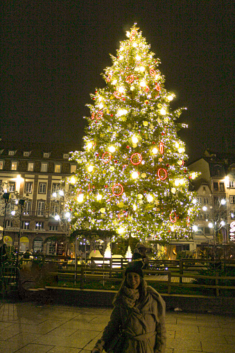 Image of a woman in front of the Christmas tree of Kleber Square in Strasbourg