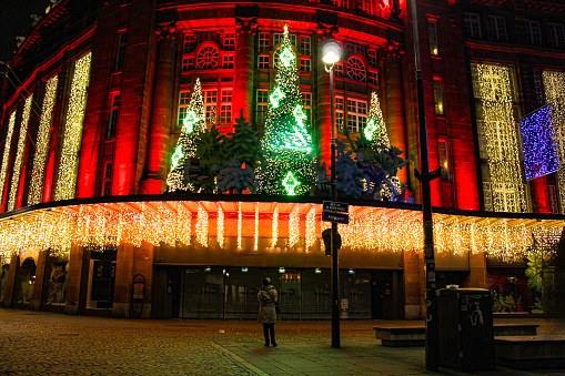 Image of the streets of Strasbourg illuminated for Christmas. The image was taken in one of the streets next to the Kleber Square in the city center of Strasbourg. There are 2 different model release from the same person and both are perfectly readable (you have approved some other images of her in the same batch)