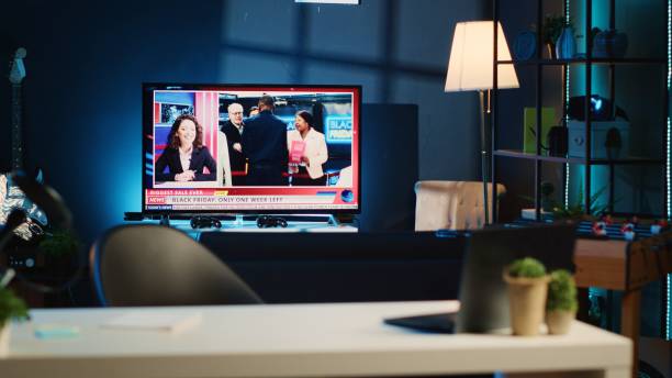 istock TV news broadcast in neon lit home 1769488430