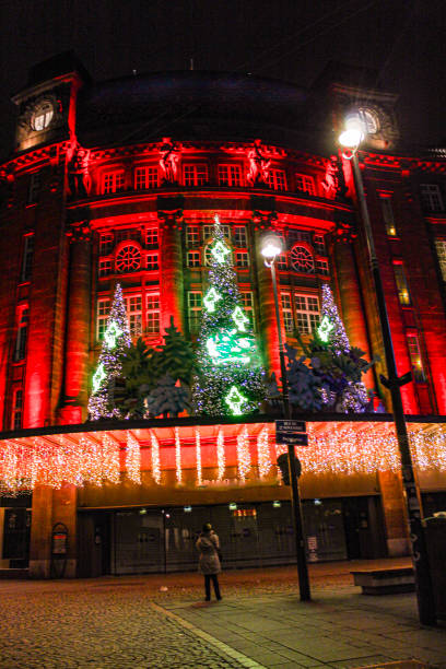 Image of a woman enjoying Christmas lights in Strasbourg. The image was taken in one of the streets next to the Kleber Square in the city center of Strasbourg. There are 2 different model release from the same person and both are perfectly readable (you have approved some other images of her in the same batch)