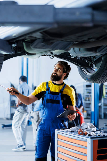 istock Worker checks suspended car wheels 1769507626