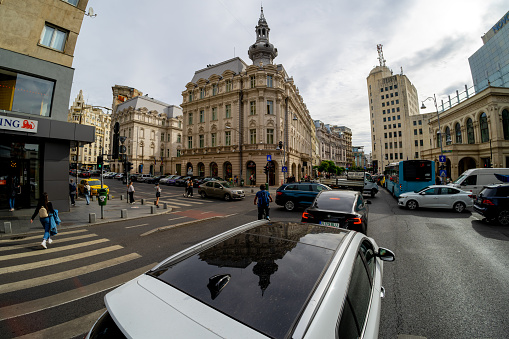 Bucharest, Romania - October 27, 2023: Wide view of the beautiful Victoriei Boulevard at the intersection with Grand Hotel Continental.