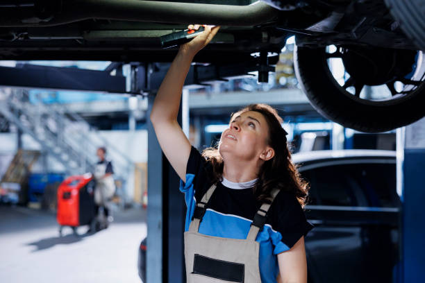 istock Mechanic checks motor on suspended car 1769513883