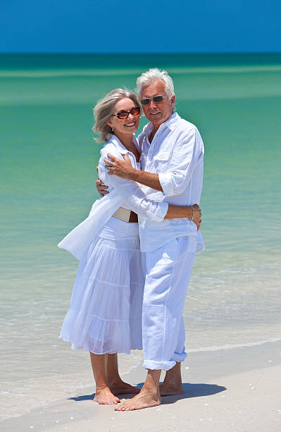 istock Happy Senior Couple Embracing on A Tropical Beach 176951634