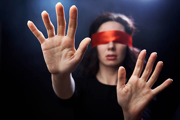 Portrait of woman with red bandage on eyes stock photo
