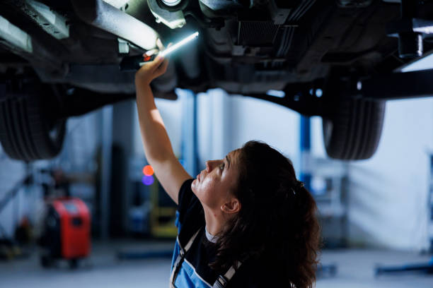 istock Garage worker checks suspended car tires 1769521265