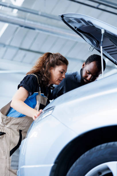istock Mechanics working to fix car distributor 1769526660