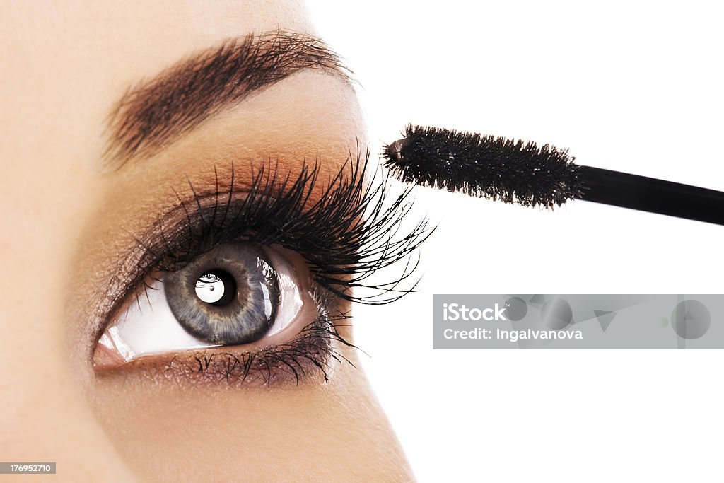 Woman eye Woman applying mascara on her long eyelashes Mascara Stock Photo