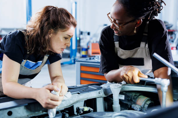 istock Repairmen fix car mechanisms in garage 1769530802