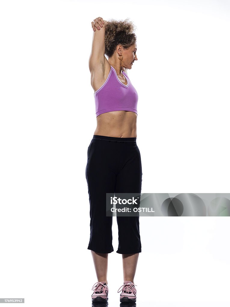Matura donna allenamento fitness postura corretta rotazione stretching - Foto stock royalty-free di Abbigliamento sportivo