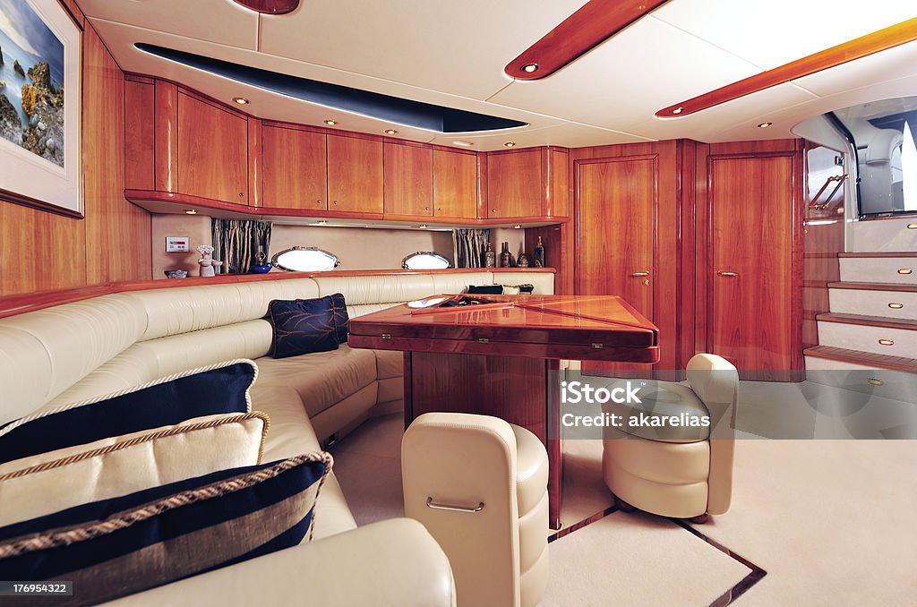 Living room area of a yacht, with a couch, table. and chairs Interior picture of a luxury yacht Nautical Vessel Stock Photo