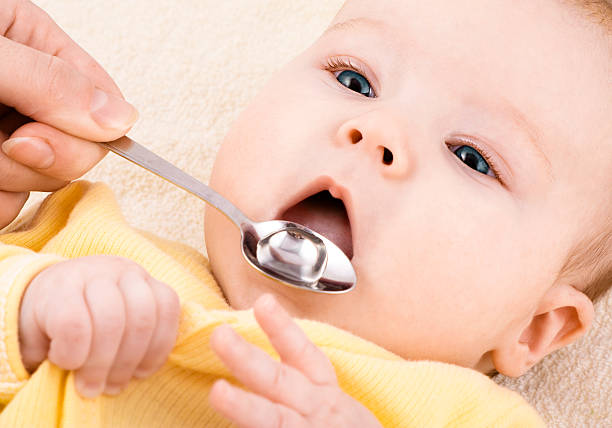 istock Child is drinking medicine syrup or water 176954360