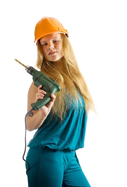 istock girl in hard hat with drill 176954547