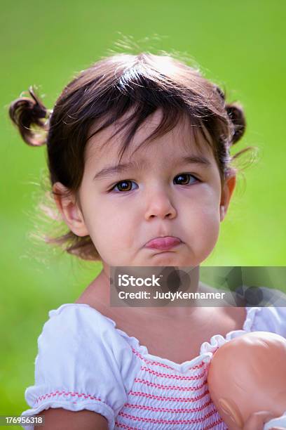 Baby Girl With Bottom Lip Stuck Out Pouting Stock Photo - Download Image Now - Puckering, 12-17 Months, 12-23 Months