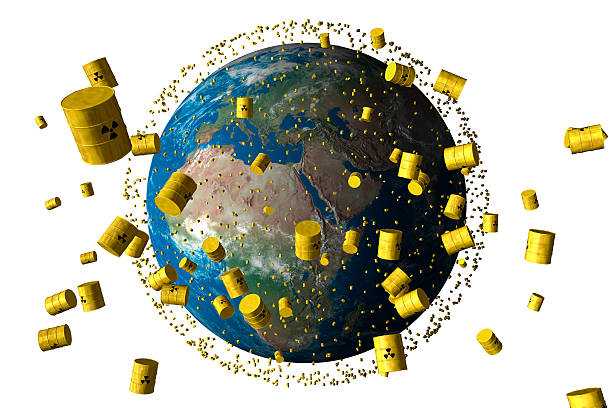 yellow barrels of nuclear waste orbit the planet earth stock photo