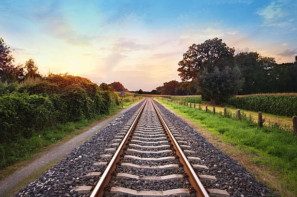 railway tracks railway tracks in a rural scene with nice pastel sunset tramway stock pictures, royalty-free photos & images