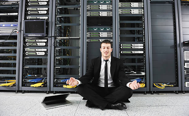istock Smiling businessman doing yoga in a network server room 176958718