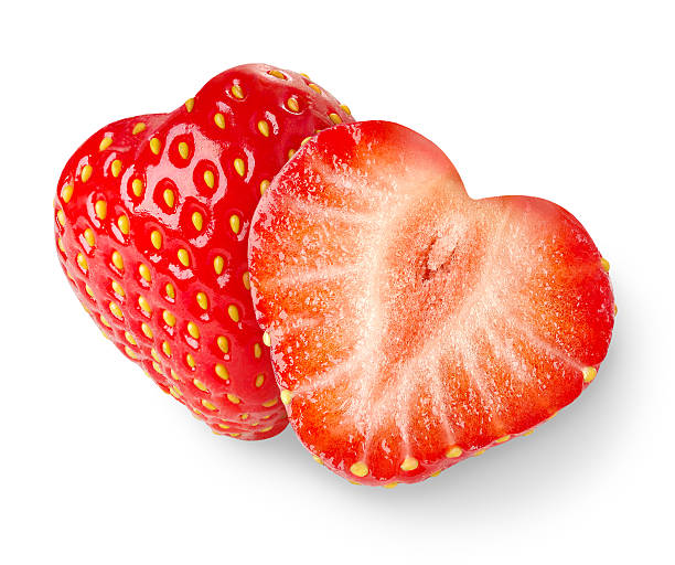 A strawberry cut in half with a white backboard