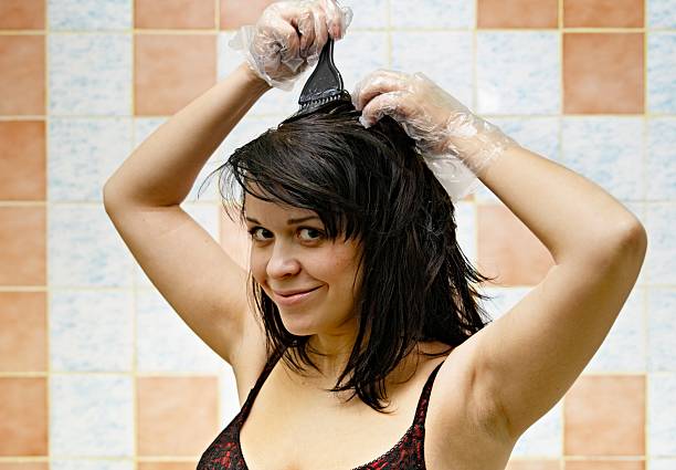 woman dyeing hairs stock photo