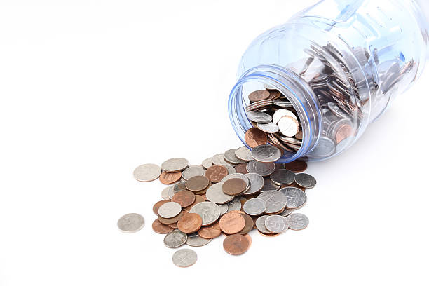 istock Coins spilling out of a jar 176960308