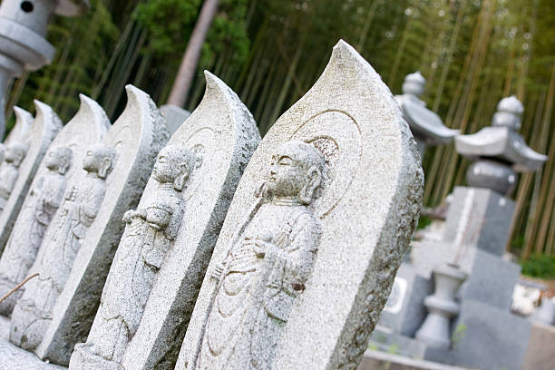 Statues of monks on a japanese graveyard stock photo