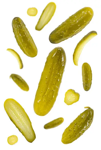 Pickled dill cucumbers against white background