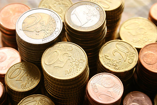stacks of euro coins of different denominations - euro stockfoto's en -beelden