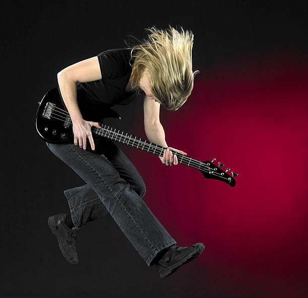 istock jumping bass guitar woman 176961507