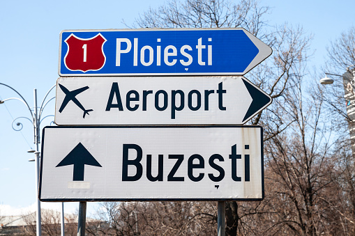 Picture of the roadsign indicating the direction to Ploiesti and Buzesti on a romanian road of bucharest, romania, with as well the direction to the bucharest airport.
