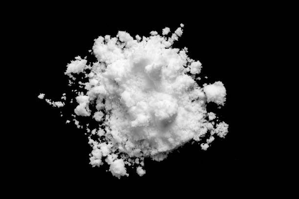 istock White snow isolated on black background close up 1769624146