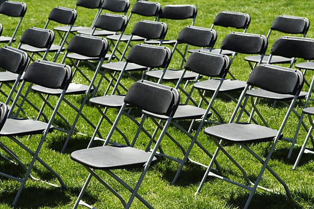 Folding Chairs - Fronts Rows of folding chairs on a lawn folding chair stock pictures, royalty-free photos & images
