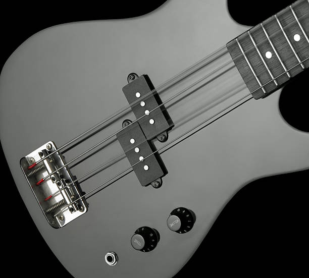 bass guitar detail detail of a black bass guitar in dark back regler stock pictures, royalty-free photos & images