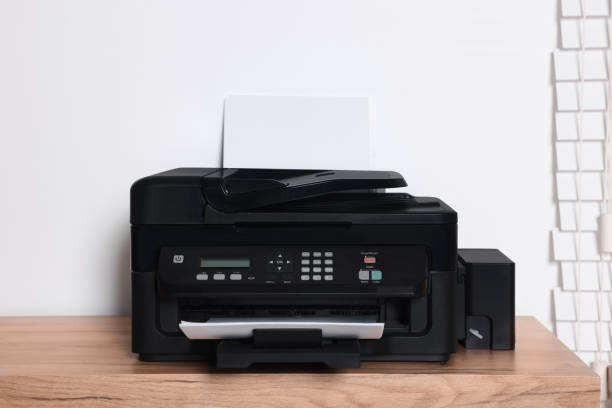 istock Modern printer with paper on wooden table indoors 1769628146