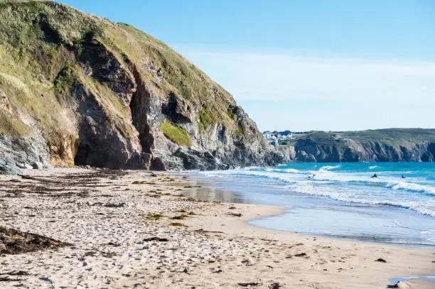 Sandy beach of Perranporth in West Cornwall, South West England. View of the beach, blue sea and cliffs. Selective focus