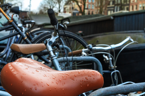 Cityscape on a rainy day - view of the bicycle parking close-up in the historic center of Amsterdam, the Netherlands