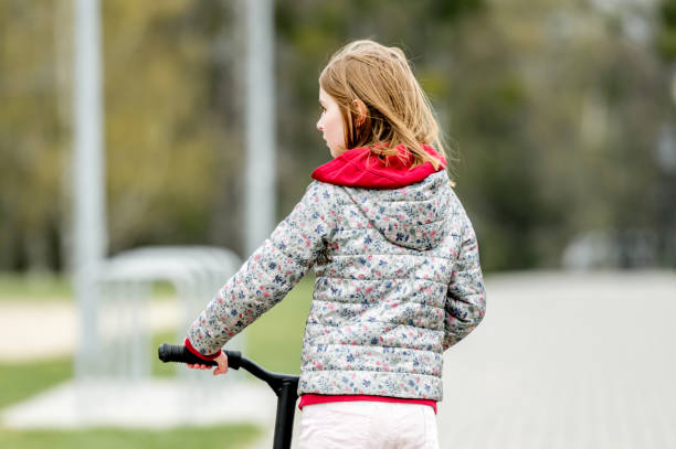 istock Little cute girl riding a scooter 1769638821