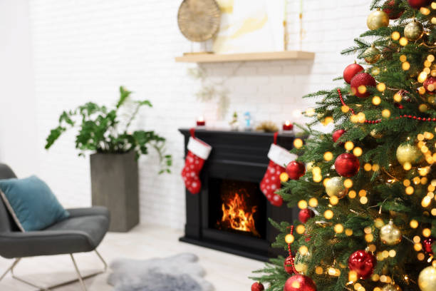 istock Beautiful Christmas tree near fireplace in room. Interior design 1769638995