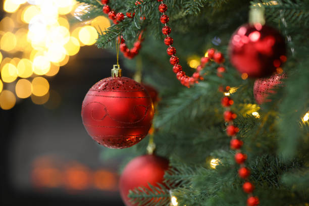 istock Closeup of red baubles hanging on Christmas tree, space for text. Bokeh effect 1769639011