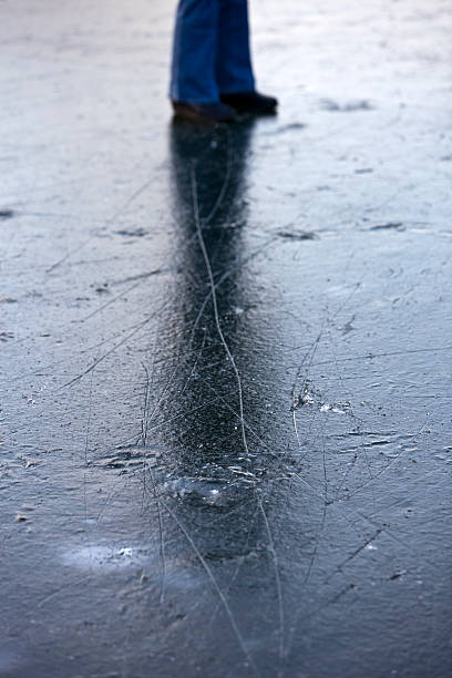 istock venturesome person standing on slippery frozen river 176965387